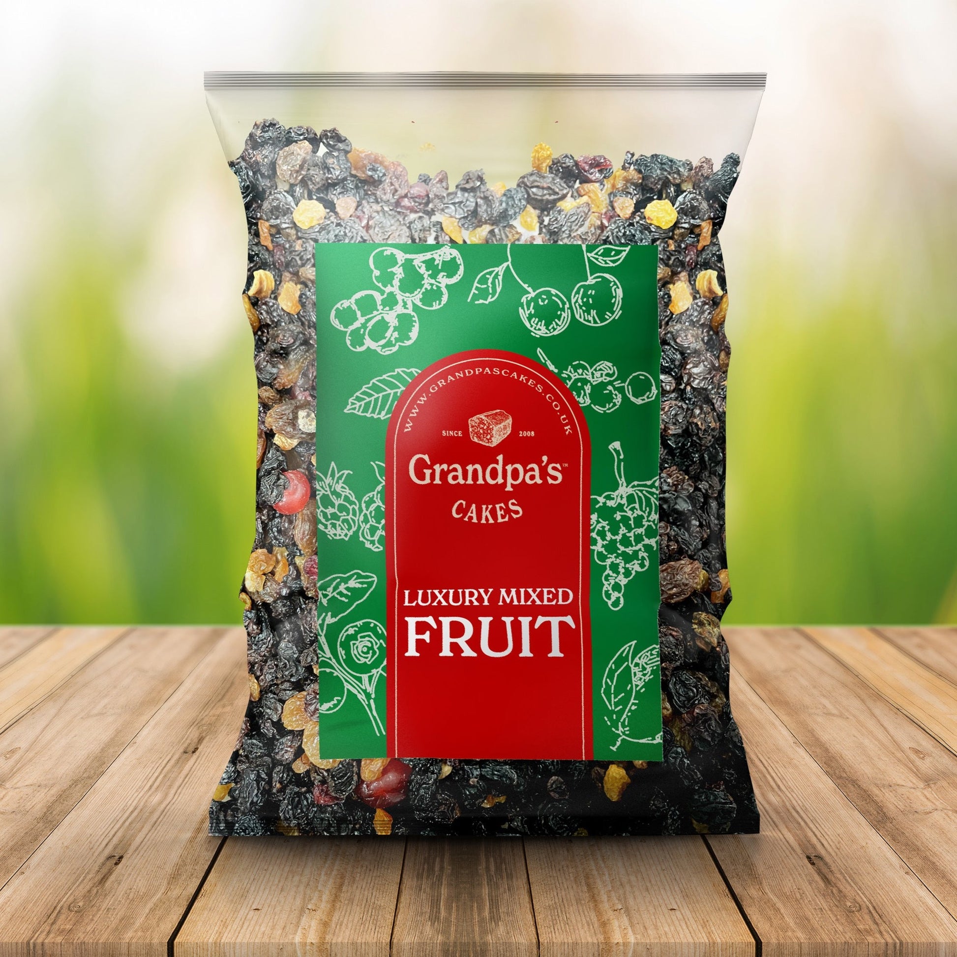 package of Grandpa's Cages luxury mixed fruit, showing a mix of dried fruits against a green label with illustrations of fruits and a red banner.