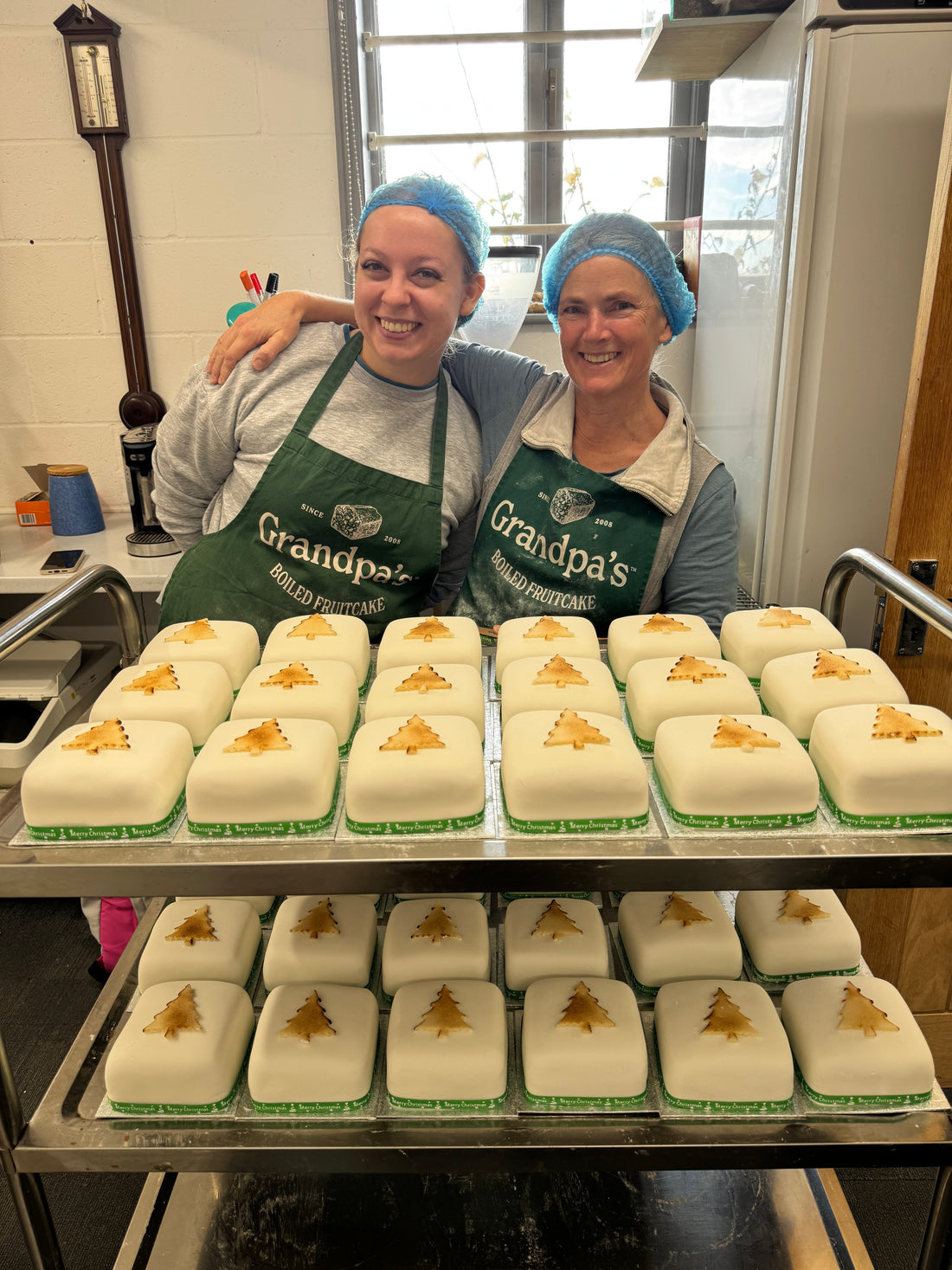 “Handmade corporate fruit cakes by Grandpa’s Cakes in branded boxes with ribbons and company logos, perfect for business gifts.”