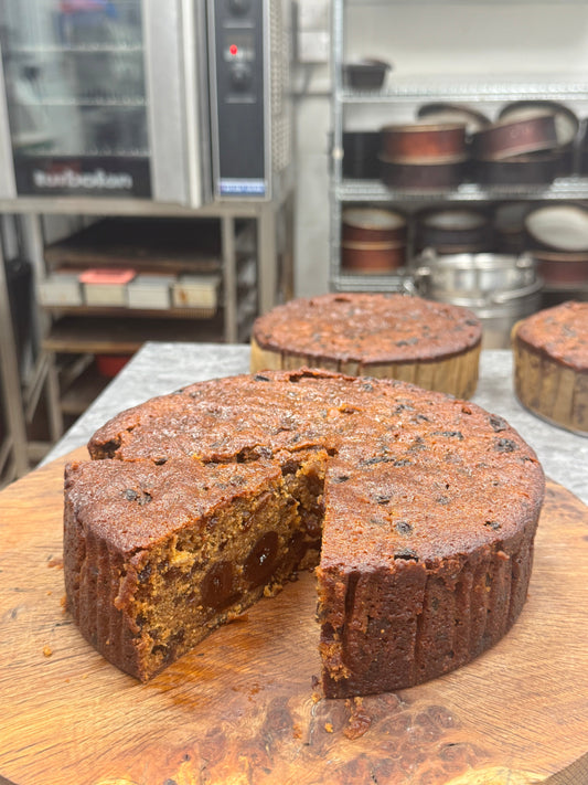 vegan fruit cake on a wooden board in Grandpas cakes bakery.