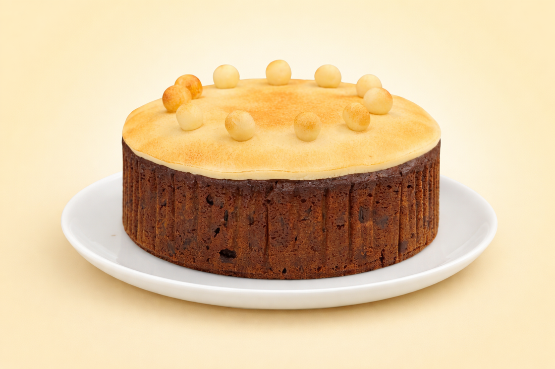 Buy simnel fruit cake – traditional Easter fruit cake with toasted marzipan topping and eleven marzipan balls on a plate