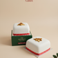 Two square cakes with a green box labeled 'Grandpa's Cakes' on a beige background.