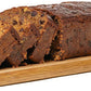 Classic fruit cake bar sliced on a wooden serving board, showing rich dried fruit texture, handmade by Grandpa’s Cakes