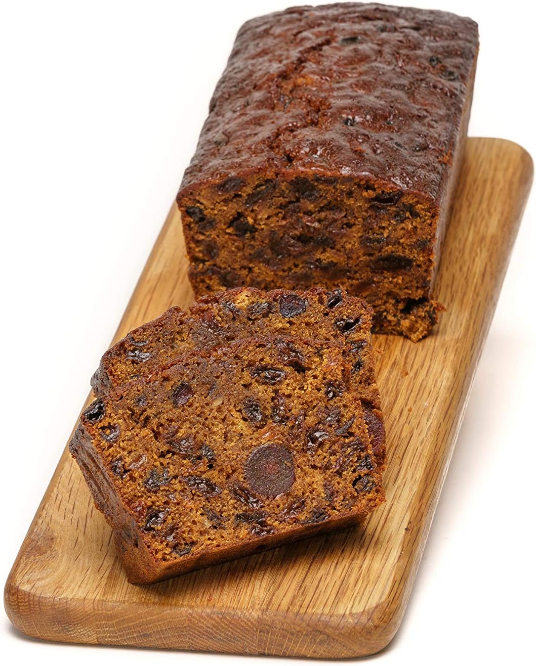 slices of moist fruit cake on a wooden board handmade by grandpas cakes.