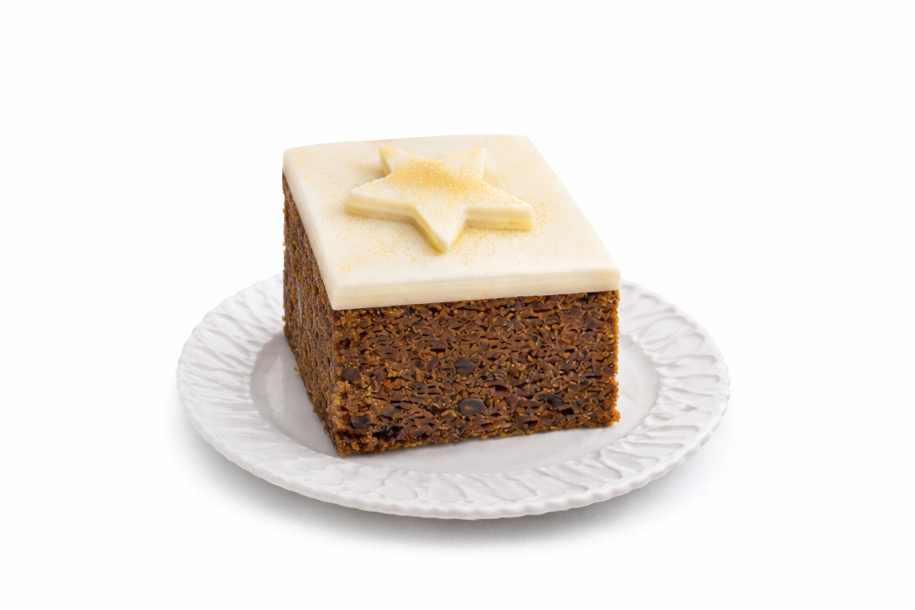 Small square celebration fruit cake topped with marzipan and icing